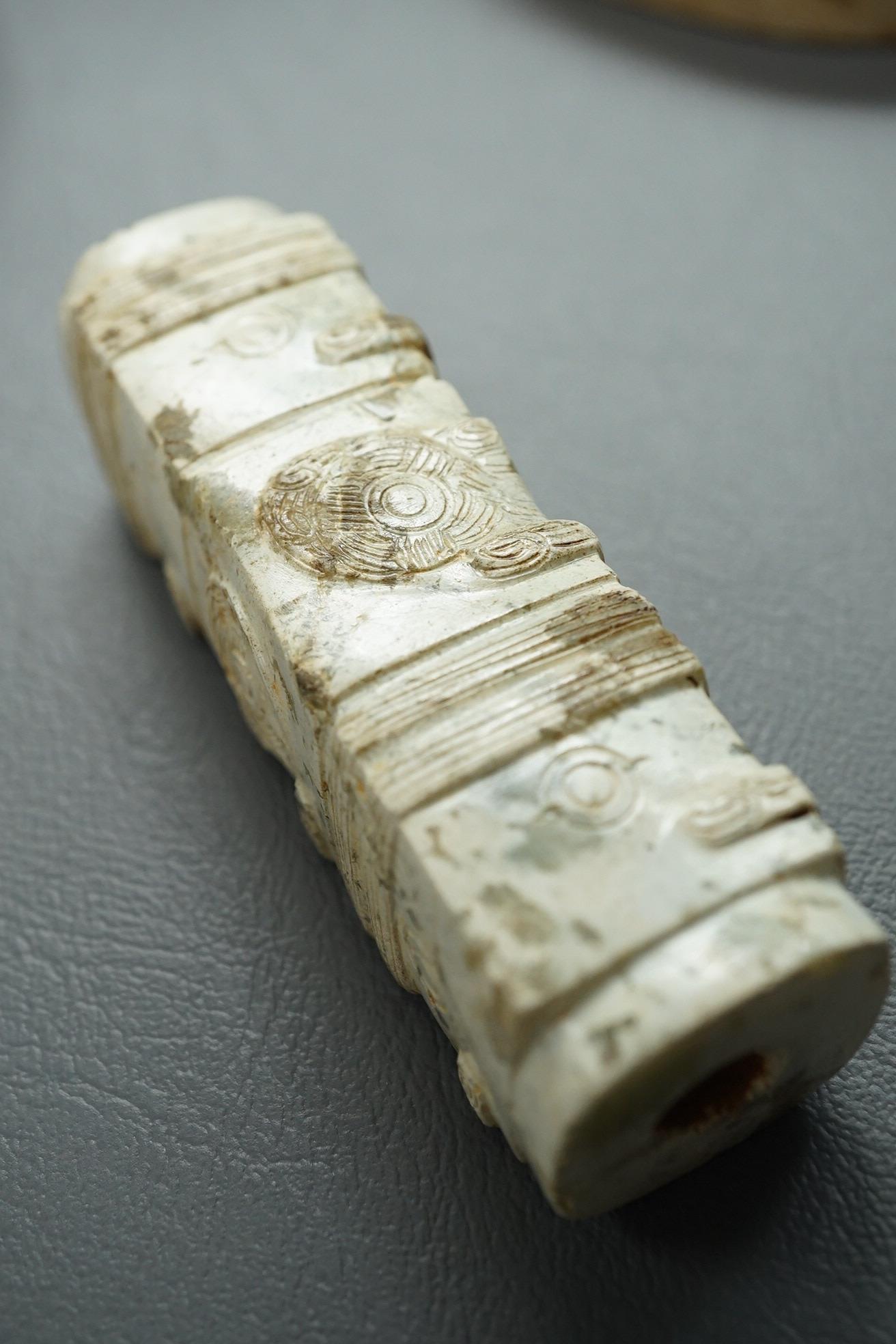 Four Chinese archaistic hardstone or burnt jade cong or cylinders